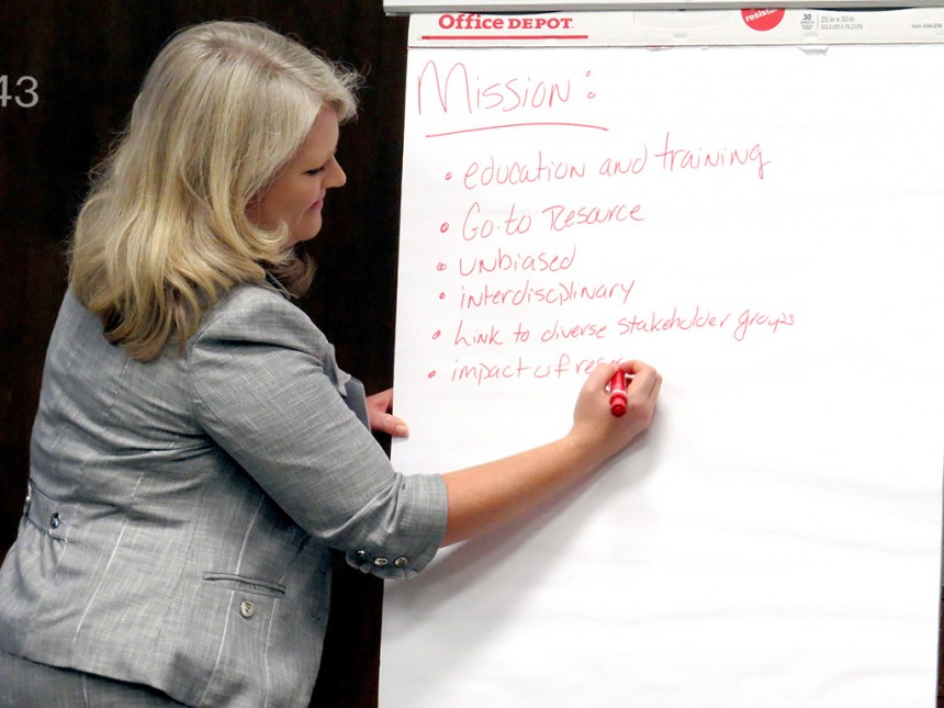Angie Lindsey takes notes at strategic planning session